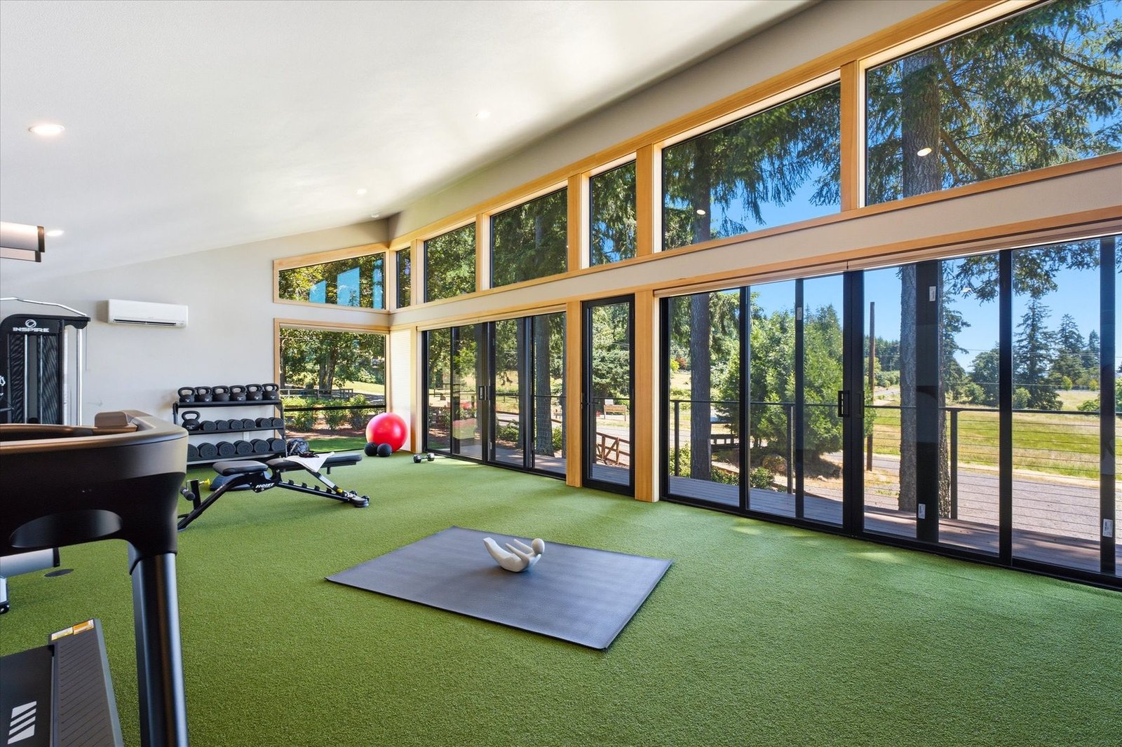 Home gym with floor to ceiling windows